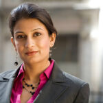 Friendly Indian Businesswoman Wearing A Suit In City Setting